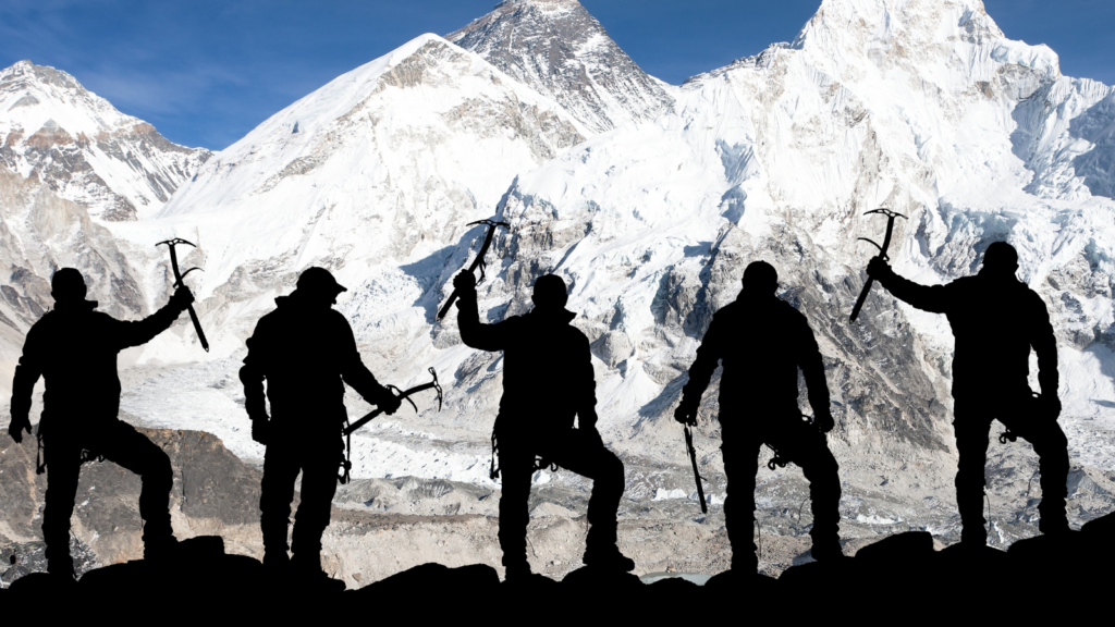 a group of 5 hikers, their silhouettes are shown against a snowy mountain backdrop. They are holding their arms and climbing equipment in the air as if cheering.