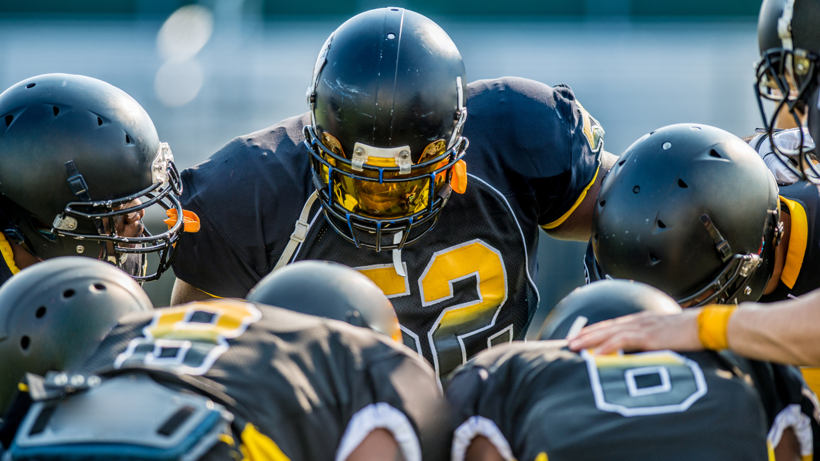 a group of football players in a huddle